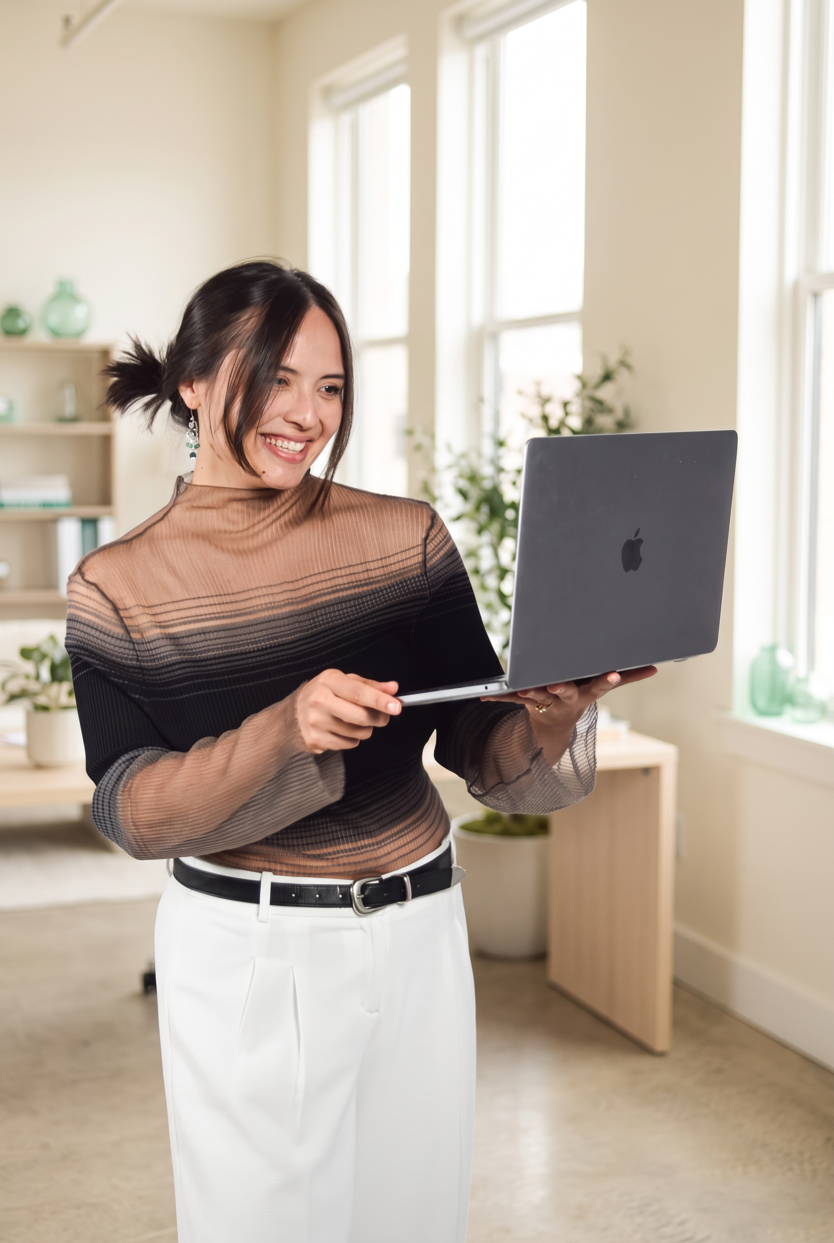Ashley Gomez reviewing client work on her laptop
